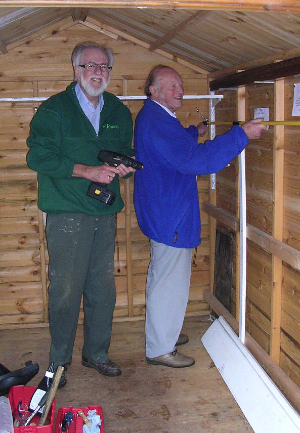 Mike Caird and Ted Matthews working in the shed